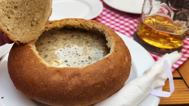 Portion of sour cereal soup, or zurek served in bread