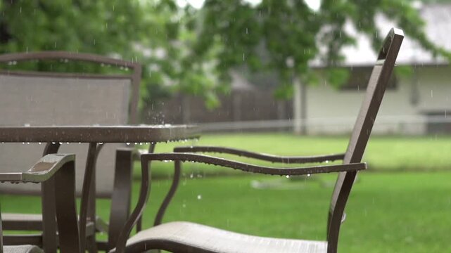 Patio furniture in rainfall slow motion
