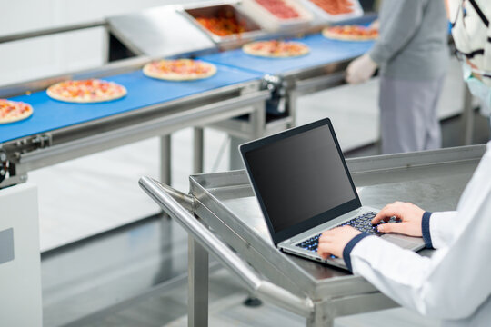 Quality Control Manager Using Laptop in Food Factory