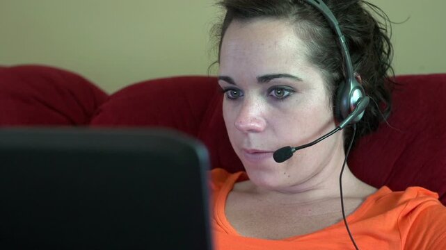 Customer service representative working form home laughing
