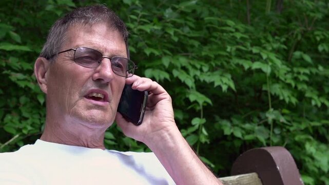 Elderly man on telephone in nature
