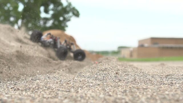 Remote control car kicking up dust slow motion
