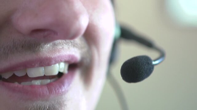 Male customer service agent talking on headset
