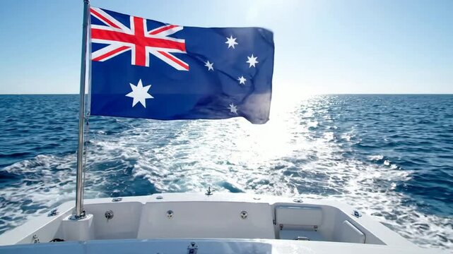 Australian flag waving on boat stern sailing across sunny blue ocean waters national flag yacht