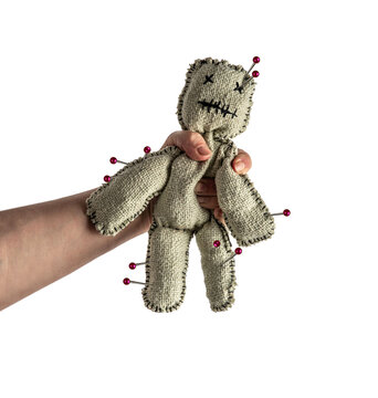 Homemade voodoo doll on isolated background. Hand squeezing toy for halloween ritual, spells, revenge