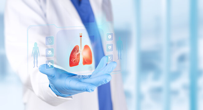Pulmonologist analyzing a lung chart for medical diagnosis and respiratory research. Light blue bokeh background.
