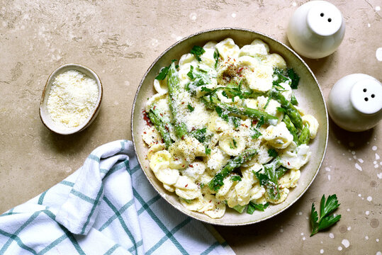 Pasta orecchiete with asparagus in a cream sause. Top view with copy space.