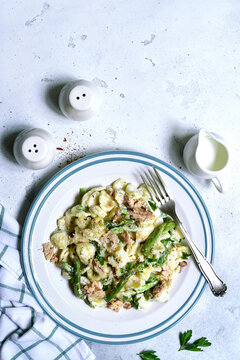 Pasta orecchiete with tuna and asparagus in a cream sause. Top view with copy space.