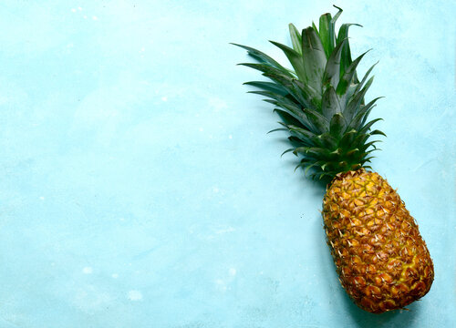 Different types of exotic fruits : pineapple, coconut, banana, orange, persimmon and pomegranate.