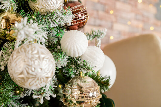 Decorating Christmas tree on bright background, White Christmas ball toy.Merry Christmas, Scandinavian style. Christmas decor. ornaments and garland lights, Christmas holidays background.