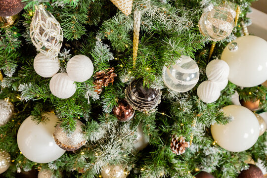 Decorating Christmas tree on bright background, White Christmas ball toy.Merry Christmas, Scandinavian style. Christmas decor. ornaments and garland lights, Christmas holidays background.