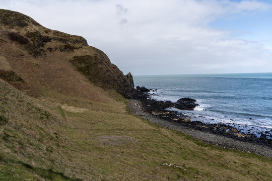 Rugged coastal landscape with cliffs and sea in County Antrim, Northern Ireland