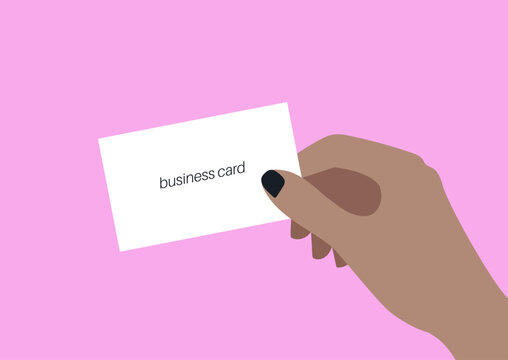 A hand gracefully presents a business card, highlighting the importance of networking and professional connections in a lively setting that inspires creativity and collaboration.