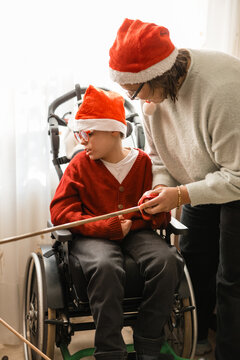 Family celebrating tio de nadal with child in wheelchair