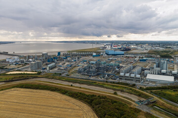 Fototapeta premium Chemical Plant Production Facility Operating Near the Humber Estuary Under a Cloudy Afternoon Sky
