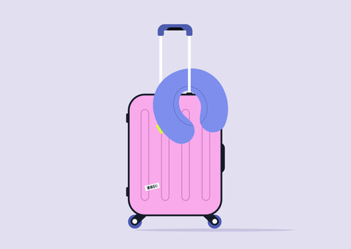 A vibrant pink suitcase rests against a soft purple backdrop, adorned with a cozy blue neck pillow, ready to enhance relaxation during travel adventures.