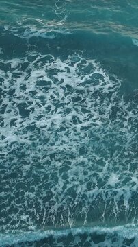 Big ocean wave. White Sea Foam Floating on Turquoise Ocean Water
