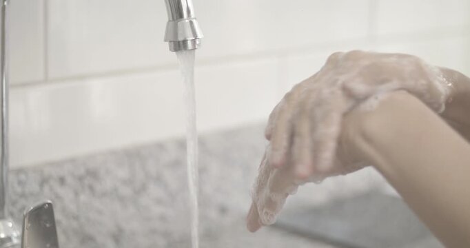 corona virus slow motion female hands washing soap and water covid
