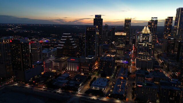 Aerial view of downtown city lights of while the sun is setting