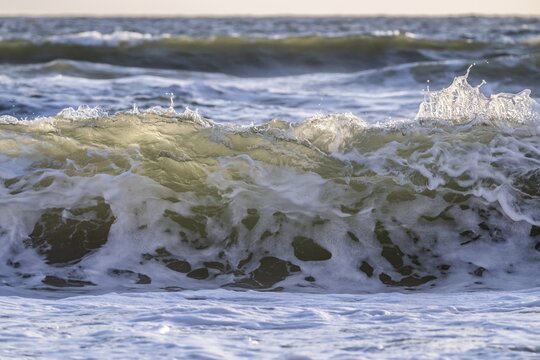 Surf, breaking wave against light, Sorteb&aelig;rdalen Strand, Houvig, North Sea, Denmark
