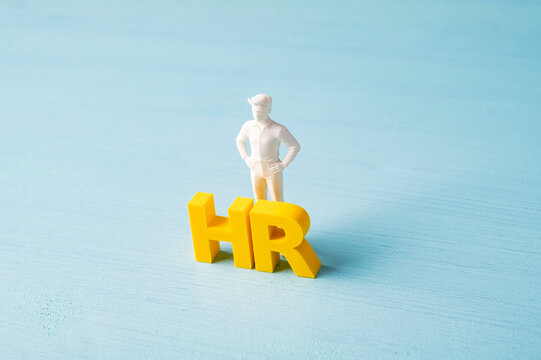Human resources HR management concept with businessman and yellow letters