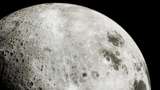 The moon is visible in the night sky with clear details. Craters and textures on the moons surface can be seen. Stars are not visible in this view.