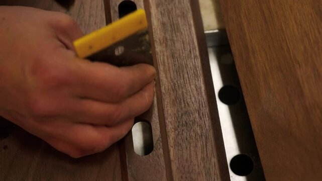 Close-up of industrial automated CNC woodworking machine cutting wood component in modern furniture factory