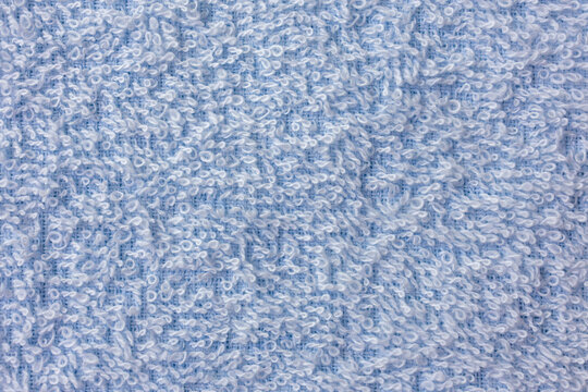 Light blue terry towel fabric texture with looped cotton surface