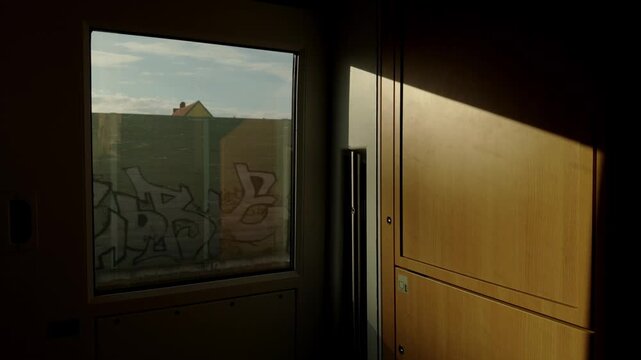 Changing patterns of sunlight and tree shadows move rapidly across a train interior as an ICE travels through the German countryside, creating an atmospheric cinematic effect.