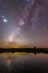 Milky Way reflected in a lake, Jupiter and Saturn in the night sky, Gamboa Lagoon in Monte Escobezo, Zacatecas © Alex Borderline