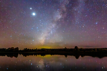 Milky Way reflected in a lake, Jupiter and Saturn in the night sky, Gamboa Lagoon in Monte Escobezo, Zacatecas © Alex Borderline