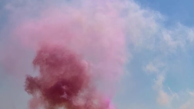 Colorful smoke clouds against a blue sky