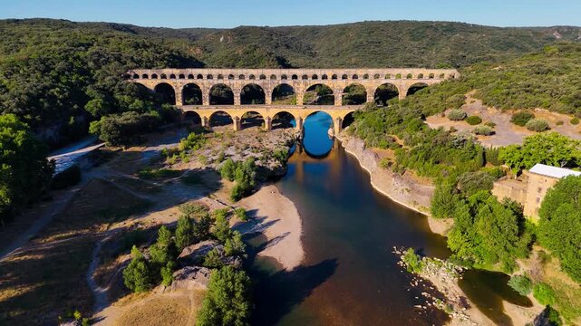 Aerial drone view of the Pont du Gard, the tallest surviving ancient Roman aqueduct from the 1st century with three tiers of arches, France. High quality 4k footage