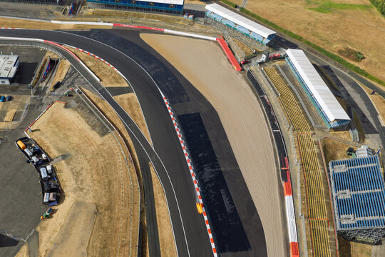 Aerial View of a Race Car Speeding Through a Sunny Silverstone Corner