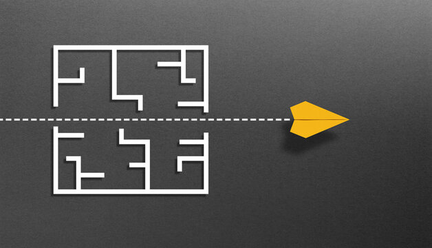 Overcoming obstacles and challenges. The way to success and business solutions. A yellow paper plane breaking through the maze on black background.