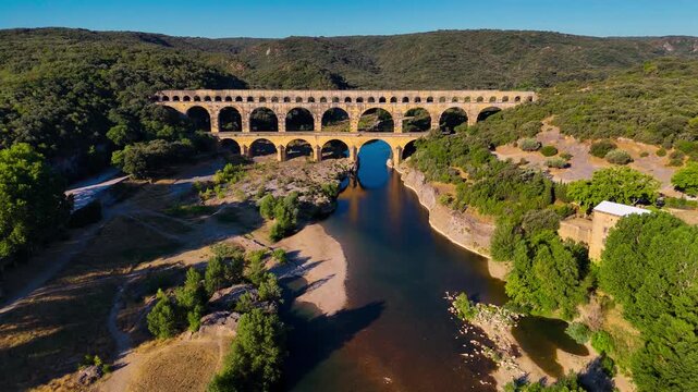 Aerial drone view of the Pont du Gard, the tallest surviving ancient Roman aqueduct from the 1st century with three tiers of arches, France. High quality 4k footage