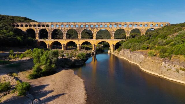Aerial drone view of the Pont du Gard, the tallest surviving ancient Roman aqueduct from the 1st century with three tiers of arches, France. High quality 4k footage