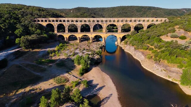 Aerial drone view of the Pont du Gard, the tallest surviving ancient Roman aqueduct from the 1st century with three tiers of arches, France. High quality 4k footage