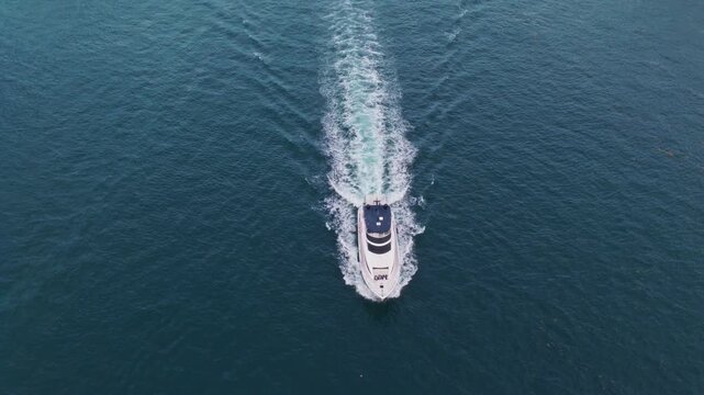 Motorboat yacht sailing at sea. Sparkling sea. Motorboat aerial top view. Luxury boat motor yacht at sea. Yachting boat tourism. Luxury lifestyle. Vacation on summer. Yacht at sea