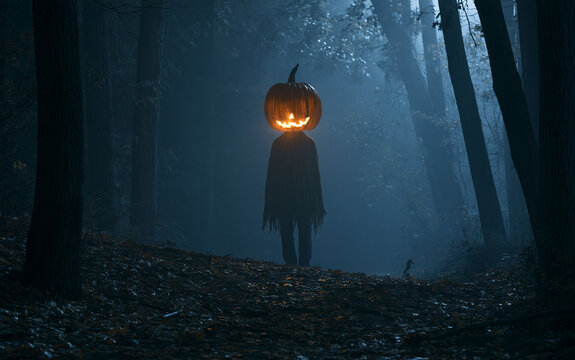 Spooky Halloween pumpkin head figure with glowing face in dark eerie forest at night