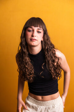Female dancer posing with urban style on yellow background