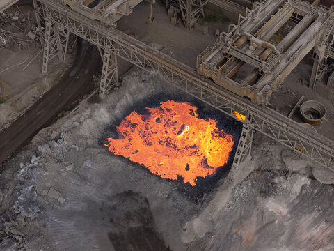 Molten Slag Poured From a Steel Mill Ladle Onto the Ground During the Day at an Industrial Facility