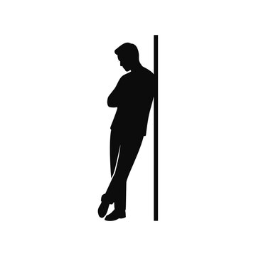 Silhouette of a man leaning against a wall