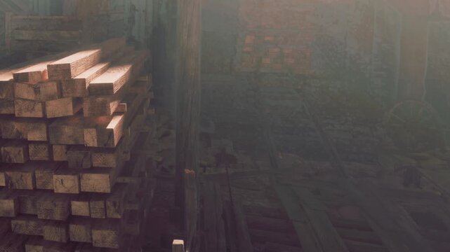 Wooden planks are piled up in a dimly lit interior of a building. The space appears worn and displays signs of age. Dust floats in the light coming through the upper area.