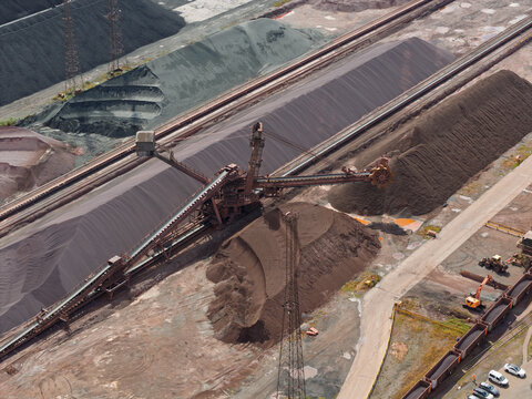 Bucket Wheel Excavator Mining Coal at an Industrial Site During a Bright Summer Afternoon in Russia