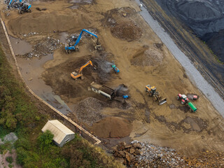 Heavy Machinery Moves Dirt and Waste at a Quarry Site © Tom