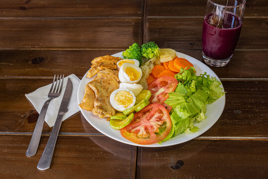 Protein Salad with Juice on Wooden Background