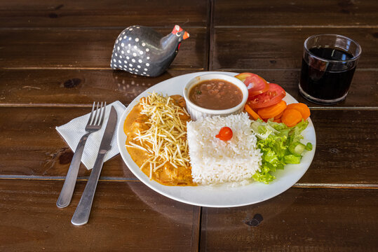 Brazilian food dish with rice beans salad