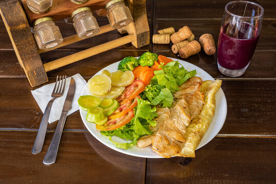 Healthy salad with juice served at restaurant