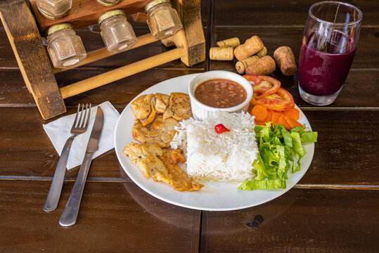 Brazilian food plate with rice beans and meat